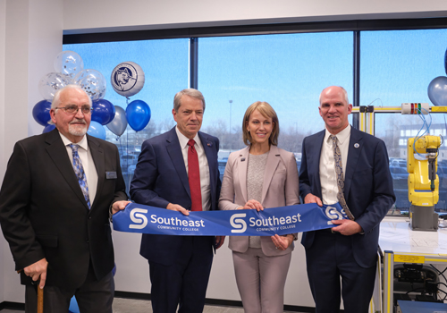 Arlyn Uhrmacher, Governor Jim Pillen, Lincoln Mayor Leirion Gaylor Baird and SCC President Dr. Paul Illich hold the ribbon at the Sandhills Global Technology Center ribbon cutting ceremony on the SCC Lincoln Campus.