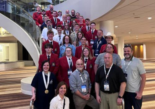SCC SkillsUSA National Qualifiers pose on a staircase at the National Skills and Leadership Conference