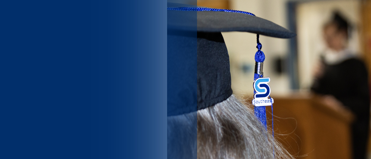 An SCC tassel is hanging off a black mortar board at SCC